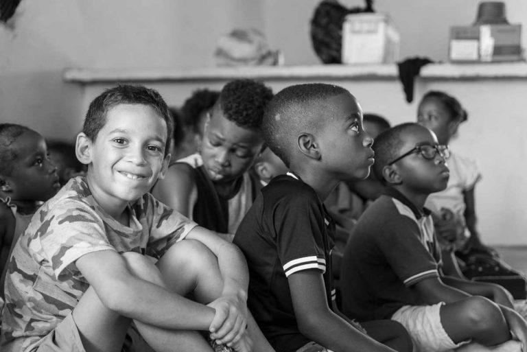 children in a room in black and white